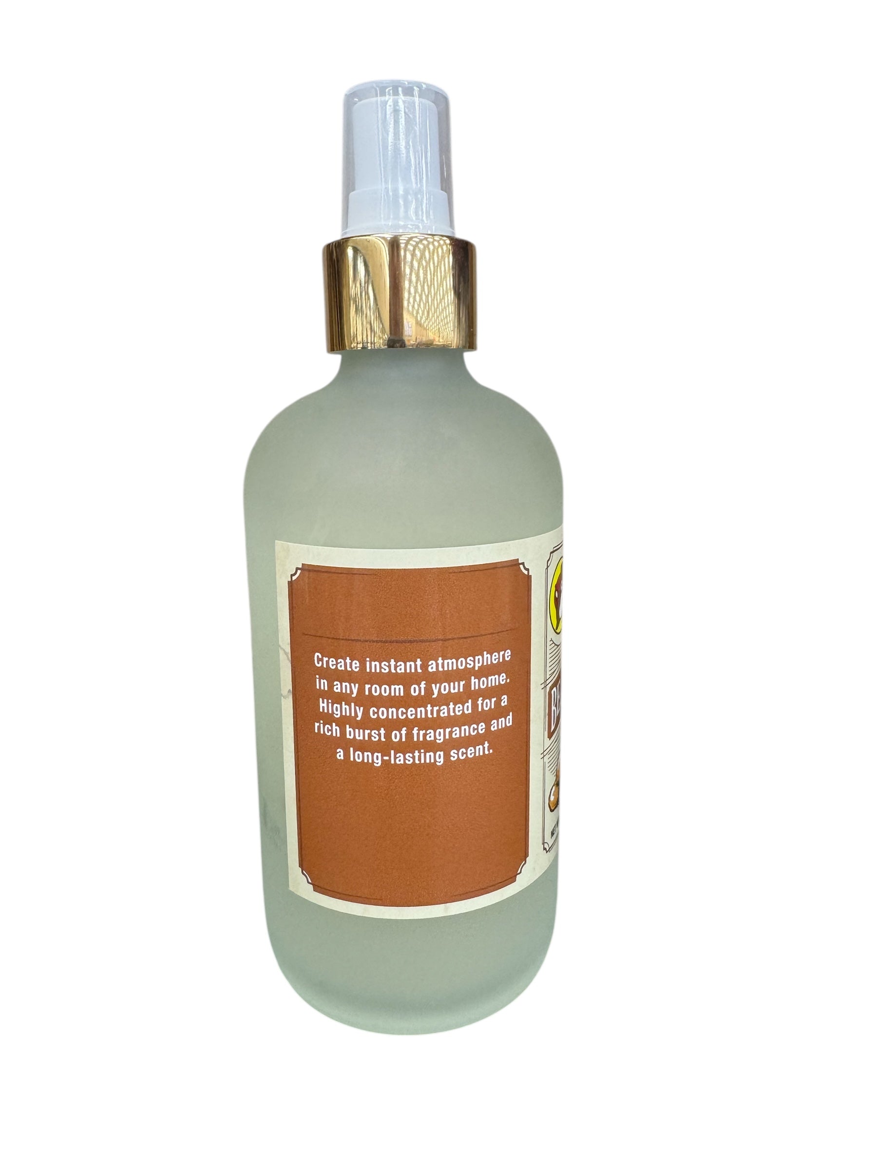 Frosted spray bottle with a gold cap and brown label on a white background